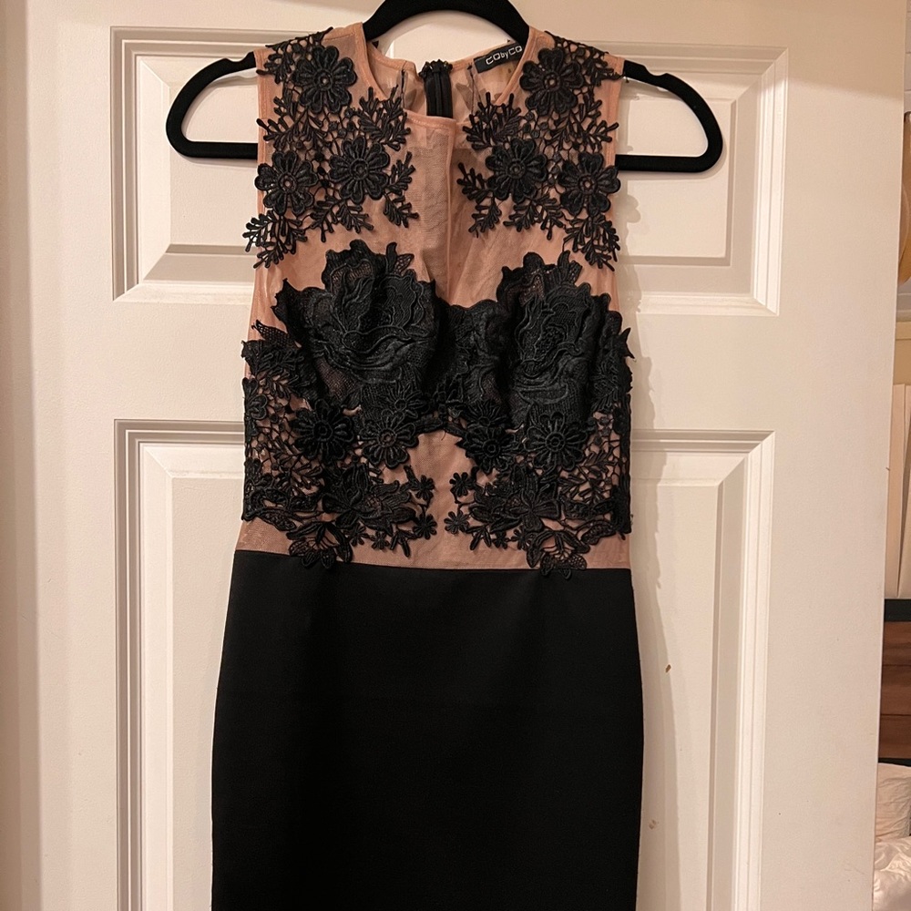 Black embroidery with nude lining.  Little black dress